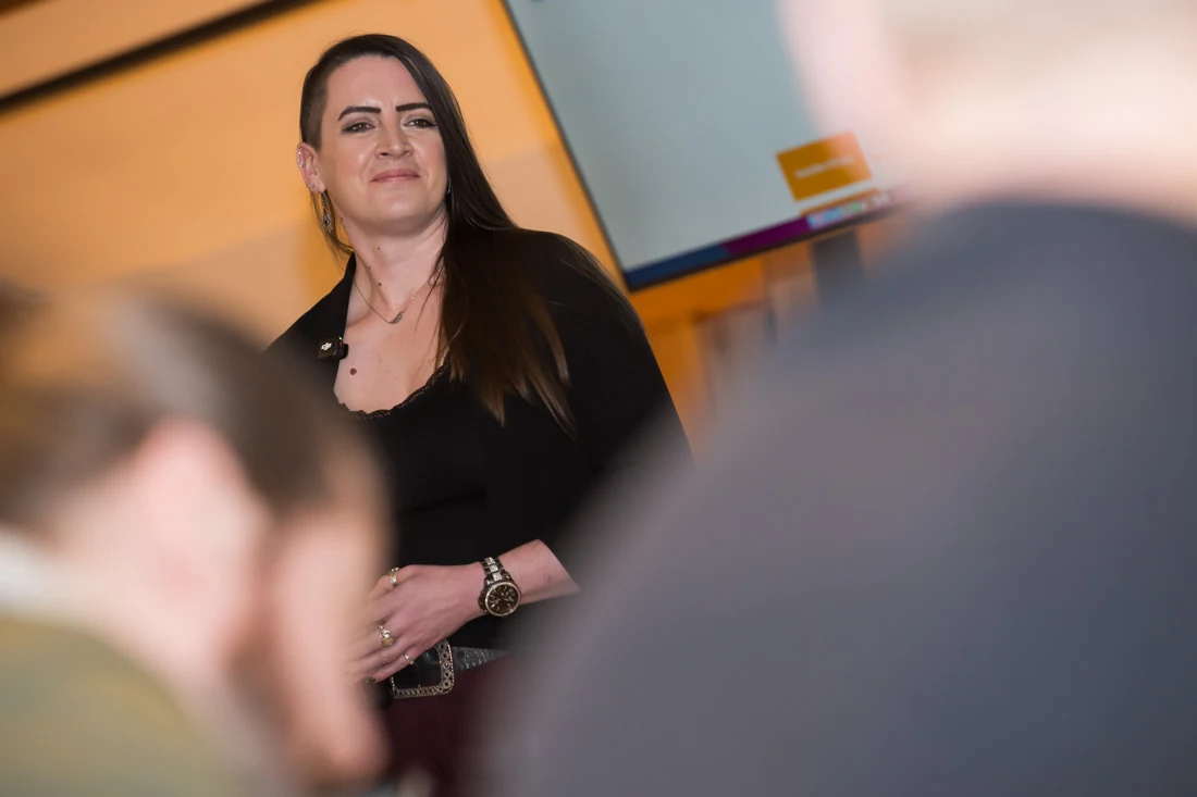 Claire presenting to an audience at an Exactly What to Say event