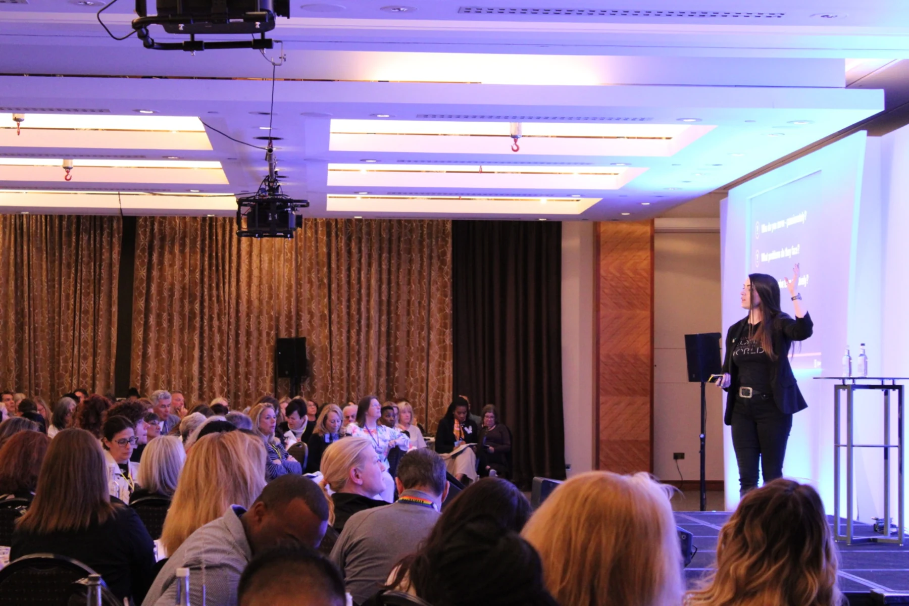 Claire presenting to an audience at Elevate London